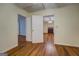 Hallway view showing multiple rooms, hardwood floors and neutral paint at 6111 Old Monticello Se St, Covington, GA 30014