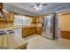 Well-lit kitchen with wooden cabinetry and stainless steel refrigerator at 6111 Old Monticello Se St, Covington, GA 30014