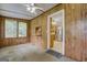 Cozy living room featuring wood paneling and a view into the adjacent kitchen at 6111 Old Monticello Se St, Covington, GA 30014
