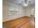 Spacious living room with hardwood floors and ample natural light, with access to other rooms at 6111 Old Monticello Se St, Covington, GA 30014