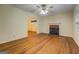 Inviting living room featuring a wood-burning fireplace and ceiling fan at 6111 Old Monticello Se St, Covington, GA 30014