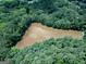 Overhead view shows a still pond, surrounded by mature trees, offering privacy and natural beauty at 6111 Old Monticello Se St, Covington, GA 30014