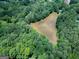 Aerial view captures the serene pond nestled within the dense woodland, highlighting property's natural charm at 6111 Old Monticello Se St, Covington, GA 30014