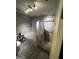 Bathroom featuring a tiled shower and tub, with gray floors and a modern light fixture at 3523 Lehigh Way, Decatur, GA 30034