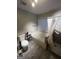 Bright bathroom featuring a shower/tub, toilet, storage shelves and modern tile flooring at 3523 Lehigh Way, Decatur, GA 30034