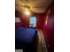 This bedroom features beautiful red walls, a window and plush carpet at 3523 Lehigh Way, Decatur, GA 30034