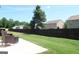 Back yard featuring patio seating, green lawn, and a dark wooden fence for privacy at 11096 Cornerstone Way, Hampton, GA 30228