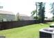 Spacious and grassy back yard with a dark wooden fence, offering privacy and room for outdoor activities at 11096 Cornerstone Way, Hampton, GA 30228