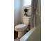 Bright bathroom featuring a toilet and bathtub with a decorative shower curtain at 11096 Cornerstone Way, Hampton, GA 30228