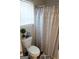 Clean bathroom featuring a toilet and a decorative shower curtain at 11096 Cornerstone Way, Hampton, GA 30228