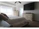 Comfortable bedroom featuring dressers, a ceiling fan, and a large window at 11096 Cornerstone Way, Hampton, GA 30228
