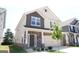 Charming two-story home featuring stone accents, brown siding, complemented by a manicured lawn, and an attached two car garage at 11096 Cornerstone Way, Hampton, GA 30228