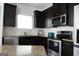 Well-equipped kitchen featuring dark cabinets, stainless steel appliances, granite countertops, and a white subway tile backsplash at 11096 Cornerstone Way, Hampton, GA 30228