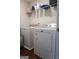Well-equipped laundry room with modern washer and dryer and overhead storage at 11096 Cornerstone Way, Hampton, GA 30228