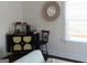 Stylish living area with a black bar cabinet, mirror wall decor, and a window bringing in natural light at 11096 Cornerstone Way, Hampton, GA 30228