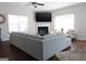 The living room offers a cozy fireplace, large windows, and comfortable seating, perfect for relaxation and entertaining guests at 11096 Cornerstone Way, Hampton, GA 30228