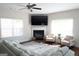 The living room offers a cozy fireplace, large windows, and comfortable seating, perfect for relaxation and entertaining guests at 11096 Cornerstone Way, Hampton, GA 30228