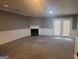 Spacious living room with neutral carpet, fireplace and white wainscoting at 2052 Charter Ln, Lithonia, GA 30058