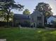 Backyard view of a two-story home with a well-maintained lawn and privacy fence at 620 Ashton Ln, Lawrenceville, GA 30044