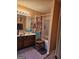 Bathroom with a vanity and mirror, complemented by neutral-colored walls and a tub/shower combo at 620 Ashton Ln, Lawrenceville, GA 30044