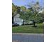 Landscaped front yard with mature tree and view of the house at 620 Ashton Ln, Lawrenceville, GA 30044