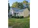 A charming home shows off its manicured lawn and tidy shrubbery at 620 Ashton Ln, Lawrenceville, GA 30044