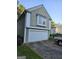 Side view of this home showing the two car garage and nice siding at 620 Ashton Ln, Lawrenceville, GA 30044