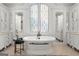 Luxurious bathroom featuring a standalone tub, large window, and elegant white cabinetry at 4874 Kettle River Pt, Suwanee, GA 30024