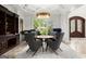 Elegant dining room with a unique chandelier, large window, and comfortable seating at 4874 Kettle River Pt, Suwanee, GA 30024