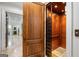 A private elevator with wooden interior and carpeted floor sits behind an open wooden door at 4874 Kettle River Pt, Suwanee, GA 30024
