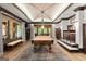 Spacious game room featuring a custom pool table, detailed trim, and large windows with backyard views at 4874 Kettle River Pt, Suwanee, GA 30024
