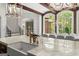 Luxury kitchen featuring a farmhouse sink, marble countertops, stainless steel appliances, and breakfast area at 4874 Kettle River Pt, Suwanee, GA 30024