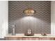 Kitchen detail featuring unique backsplash, pendant lighting, and modern accents on marble countertop at 4874 Kettle River Pt, Suwanee, GA 30024