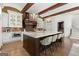 Spacious kitchen featuring a large island with seating, modern appliances, and brick backsplash at 4874 Kettle River Pt, Suwanee, GA 30024