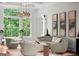Bright living room featuring neutral decor, large windows, and stylish light fixtures at 4874 Kettle River Pt, Suwanee, GA 30024