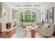 Bright and airy living room featuring high ceilings, large windows and neutral decor at 4874 Kettle River Pt, Suwanee, GA 30024