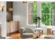 Elegant living room featuring a stylish sitting area, a chic cabinet, and bright natural light at 4874 Kettle River Pt, Suwanee, GA 30024