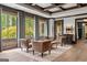 Comfortable living area with coffered ceilings, hardwood floors, and a view of the outdoors at 4874 Kettle River Pt, Suwanee, GA 30024