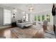 Spacious main bedroom featuring textured wall, chandelier, sitting area and hardwood floors at 4874 Kettle River Pt, Suwanee, GA 30024