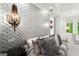 Chic main bedroom with decorative textured wall, pendant lights and luxurious bedding at 4874 Kettle River Pt, Suwanee, GA 30024