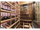 Custom wine cellar featuring wood racks, climate control, and organized bottle storage at 4874 Kettle River Pt, Suwanee, GA 30024