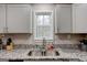Kitchen sink features granite countertops, stainless steel sink, and modern fixtures at 130 Mount Zion Sw Rd, Atlanta, GA 30354