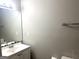 Bathroom with single sink vanity, a mirror, neutral paint, and a standard toilet at 3589 Burlingham Dr, Lithonia, GA 30038