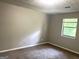 Carpeted bedroom with a single window with blinds, neutral walls, and textured ceiling at 3589 Burlingham Dr, Lithonia, GA 30038
