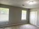 Bedroom featuring carpet, two windows with blinds, closet, neutral walls, and textured ceiling at 3589 Burlingham Dr, Lithonia, GA 30038