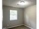 Cozy bedroom with neutral walls, carpet, and a window providing natural light, creating a comfortable space at 3589 Burlingham Dr, Lithonia, GA 30038