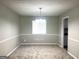 Cozy dining room with neutral walls and carpet, featuring a chandelier and a view of the backyard at 3589 Burlingham Dr, Lithonia, GA 30038