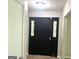 Welcoming entryway featuring a decorative black door with glass accents, tile flooring, and neutral walls at 3589 Burlingham Dr, Lithonia, GA 30038