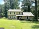 Inviting two-story home with a stone facade and well-maintained lawn, nestled in a serene, wooded setting at 3589 Burlingham Dr, Lithonia, GA 30038