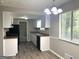 Functional kitchen featuring white cabinets, modern appliances, ample counter space, and bright lighting at 3589 Burlingham Dr, Lithonia, GA 30038